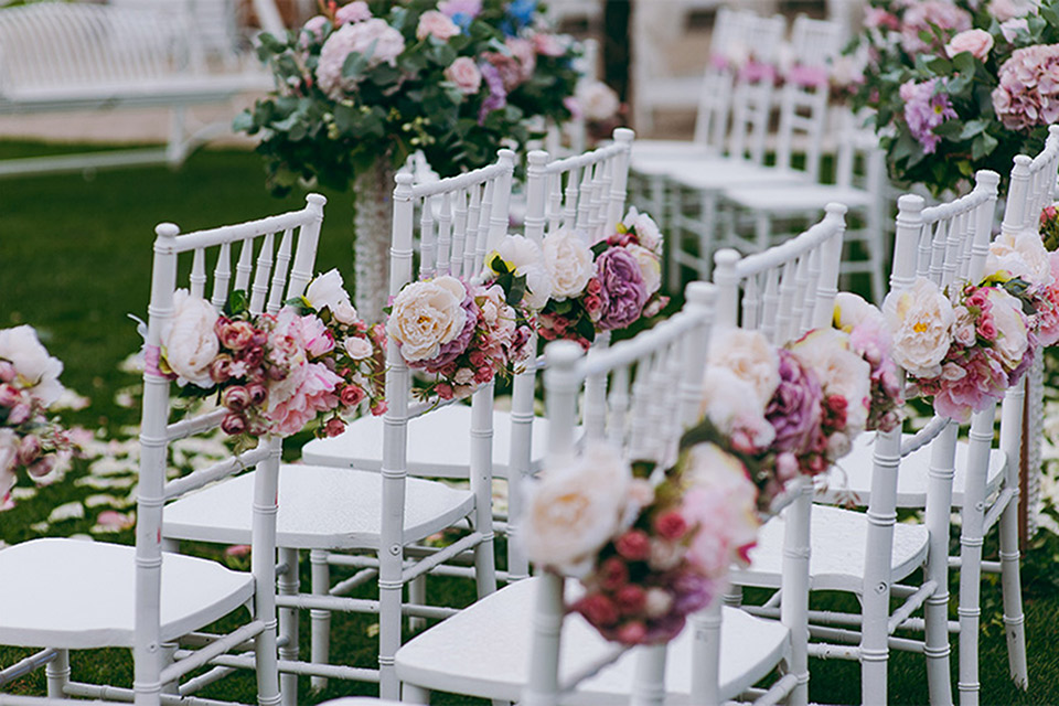 Chairs decorated with flowers for a wedding at Grove Winery.